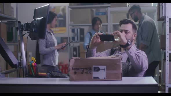 Worker Photographing Damaged Package