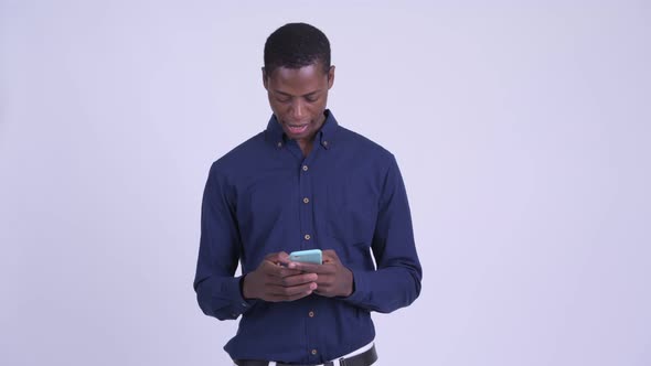 Young Stressed African Businessman Using Phone and Getting Bad News