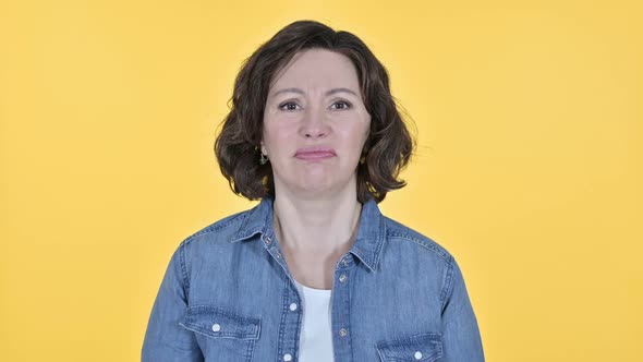 Old Woman Having Loss on Yellow Background Failure