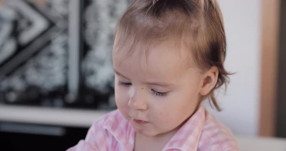 Brown Eyed Little Kid with Tail Looking Down Seriously