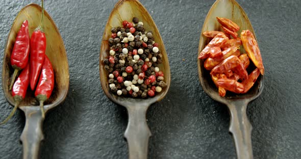 Various spices in spoon on black background 4k