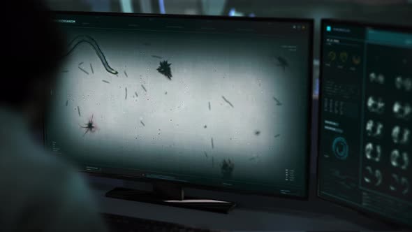 A Doctor is observing the movement of the worm virus organism at the laboratory alt