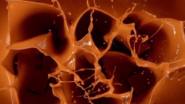 Super Slow Motion Shot of Caramel Chunks Falling Into Melted Caramel at 1000Fps