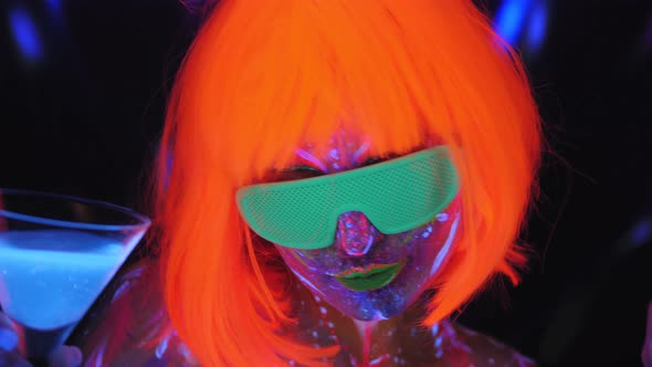 A Girl with a UV Pattern on Her Face, a Wig and Glasses with a Martini Glass.