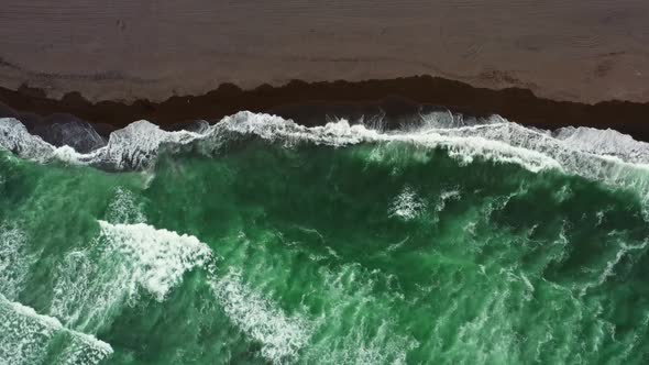 Aerial Top View of Beach with Black Sand