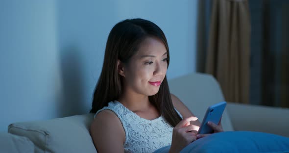 Woman use of mobile phone at night