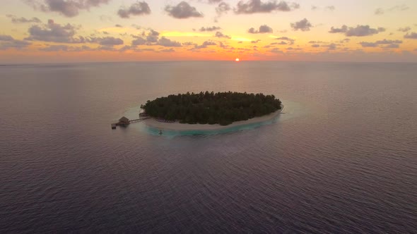 Aerial drone view of scenic tropical islands at sunset in the Maldives.