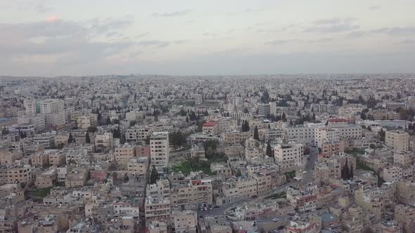 Serene early morning in Amman Jordan taken by a drone slowly descending and moving with a flock of p