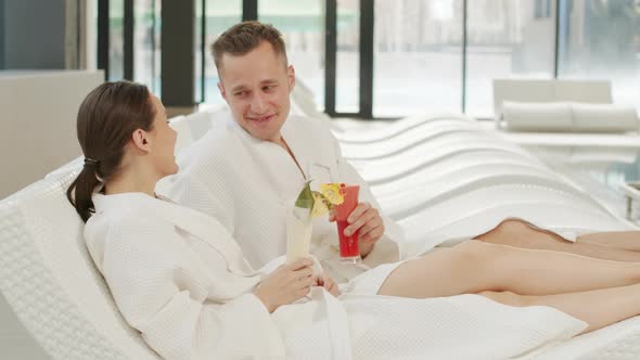 Portrait Of Smiling Couple On Loungers