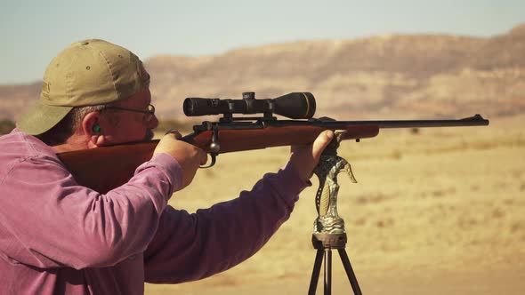 The family patriarch carefully lines up a shot at the outdoor target range on private property.   A