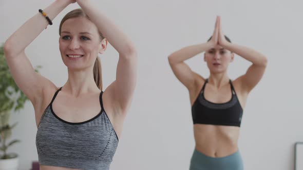 Two Female Yogi Exercising