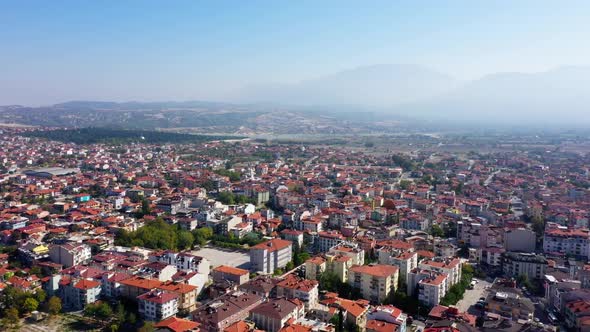 Aerial View Over the Red Roof Tiled Buildings on the Background of Mountains