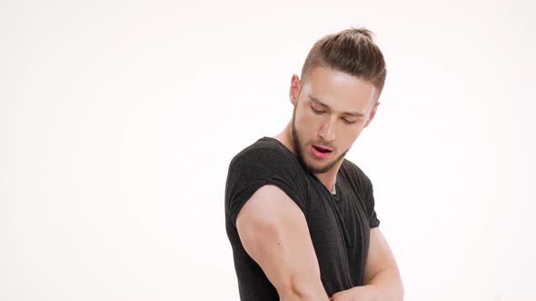 Portrait of Young Handsome Man Showing Muscles