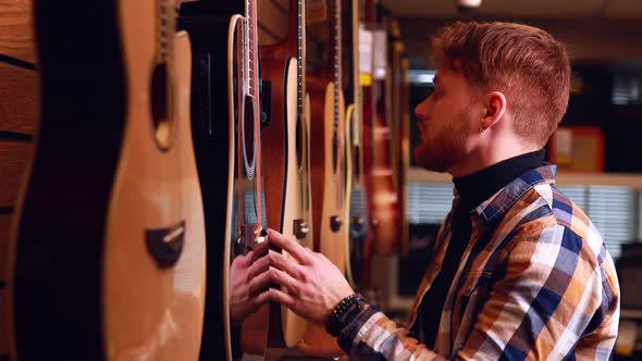 Redhair Ginger Man is Choosing Quality Acoustic Guitar in Guitar Shop