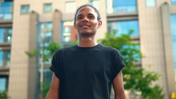 Cheerful Mixed Race Guy Walking Outdoors