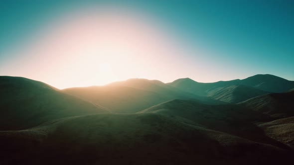 Hills with Rocks at Sunset