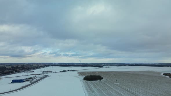 Flying over a snowy field. Traces of agricultural tillage are visible under the snow.