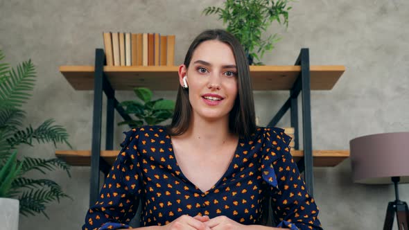 Close up smiling woman teacher looks camera teaches students online remote video call webcam laptop