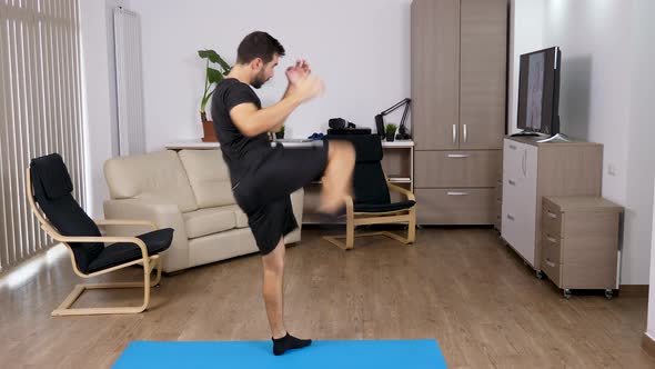 Athletic Man Kicking and Punching in the Living Room