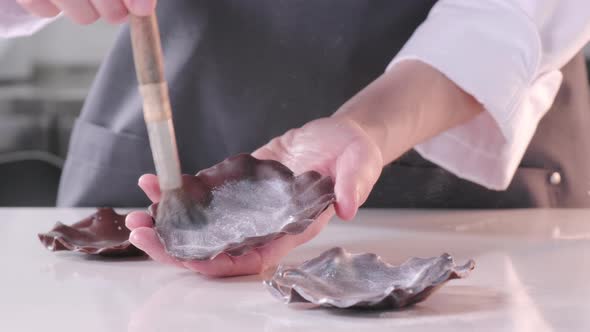 Pastry Chef Covers the Chocolate with Gray Kandurin to Decorate the Cake