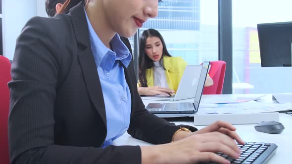 Asian employee officer attractive positive smile woman working on desktop