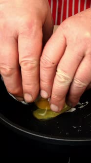 Pouring Chicken Egg Into Hot Skillet and Cooking Fried Eggs