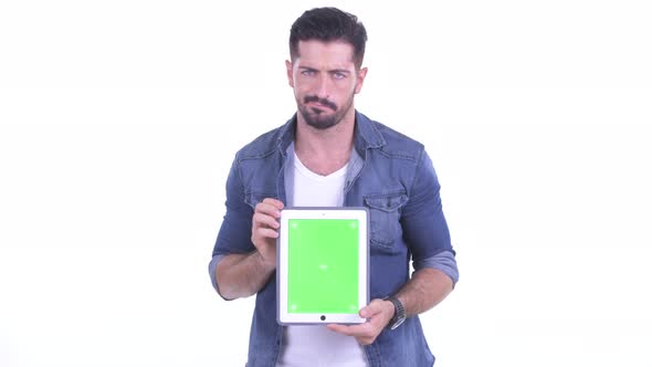 Stressed Young Bearded Hipster Man Showing Digital Tablet