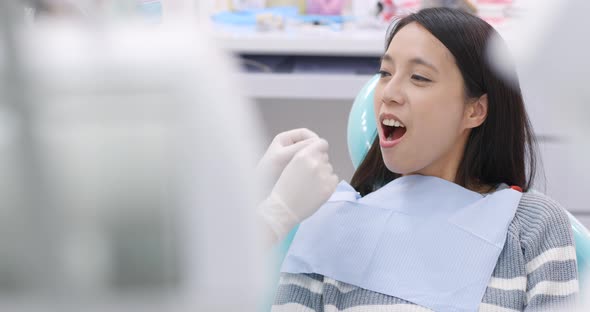 Dentist examining a patient teeth in the dentist