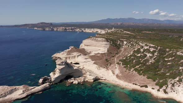 Aerial View of White Bluff Beach on Bay on the Coastline with Waves in the Blue Sea