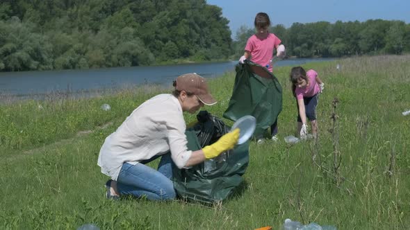 The Family Collects Trash in Nature. Eco Team in the Field