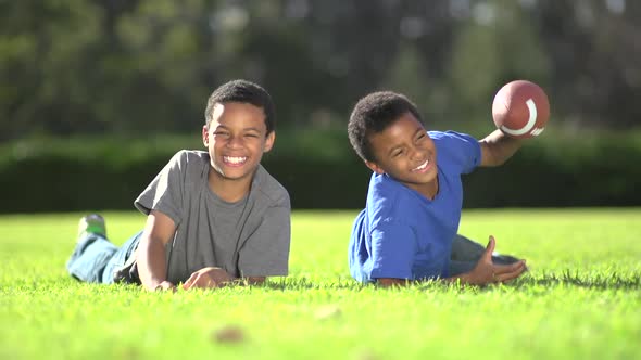 Group portrait of a father and his sons with a football