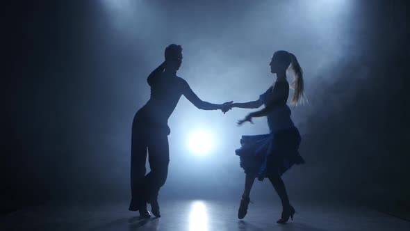 Professional Couple of Salsa Dancers Posing in Smoky Studio, Silhouette