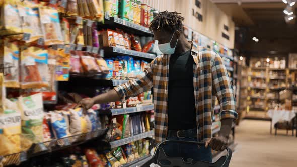 Male Customer Taking Products From the Shelf in the Supermarket Put to the Cart