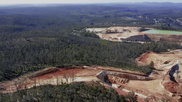 Drone aerial footage of a large coal colliery in a forest