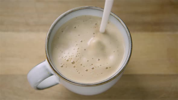 150fps SLOW MOTION WIDE frothy oat milk pours into a cappuccino