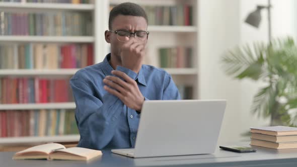 Young African Businessman Having Wrist Pain While Using Laptop in Office