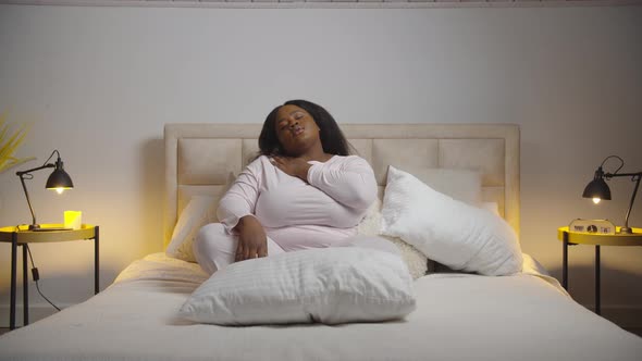 Tired African Woman Stretching Bed Before Sleep