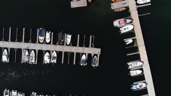 Boats moored in harbour marina, aerial bird's eye view