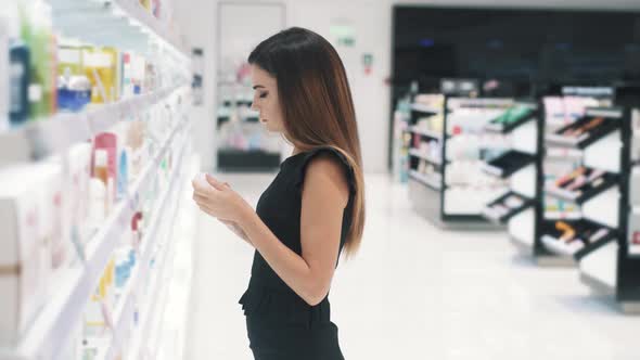 Side View of a Young Woman Sniffing Cosmetics to Make the Right Choice