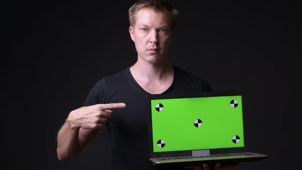 Young Handsome Man Using Laptop with Green Screen Chroma Key