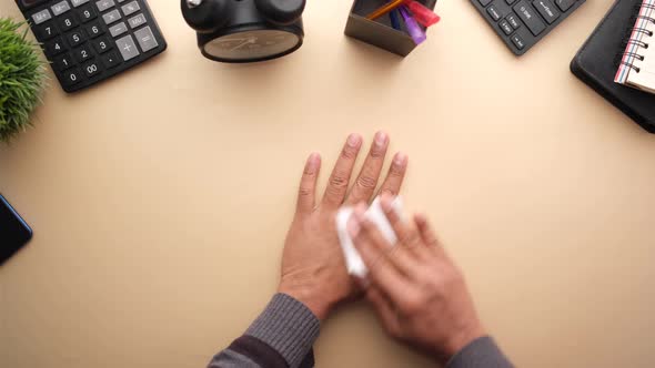 Man Disinfecting His Hands with a Wet Wipe