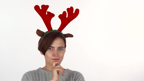 Attractive Christmas Girl Looking Thoughtfully To the Camera, Isolated
