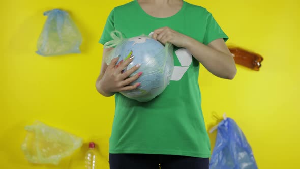 Unrecognizable Woman Makes Earth Globe Free From Plastic Package. Save Ecology. Nature Pollution