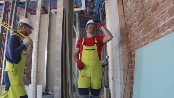 Tired Construction Worker Walking Inside Reconstructing Building