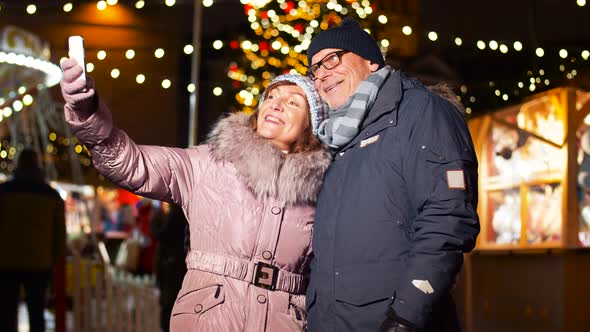 Senior Couple Taking Selfie at Christmas Market 11
