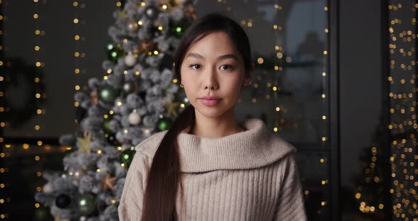 Portrait of Pretty Asian Woman at Home in the Evening on Holidays