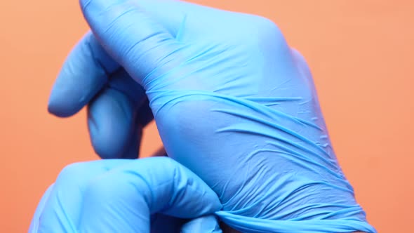 Man Doctor Wears Medical Gloves, Close Up alt