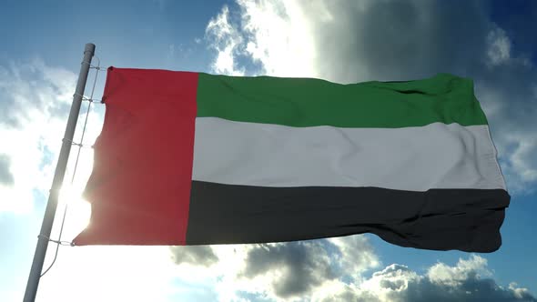 Flag of the United Arab Emirates Waving in the Air Cloudy Blue Sky in Background