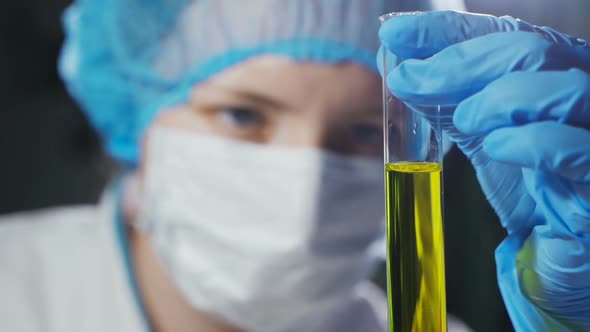 A Female Scientist Conducts a Chemical Experiment in a Modern Laboratory