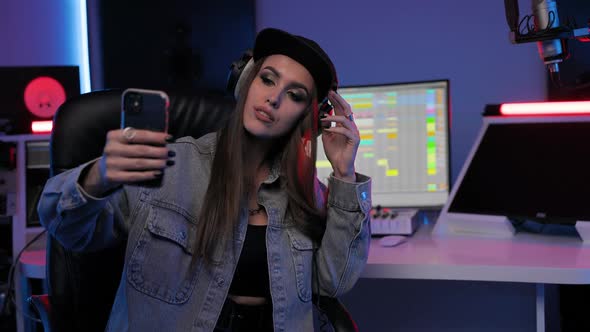 Musician Woman Sits in Chair in the Recording Studio